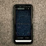Midjourney AI produces a proprietary artificial intelligence. Man holding a smartphone iPhone